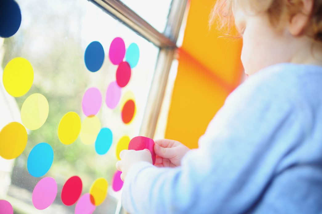 Child assessing material and synthesising aesthetic solutions.